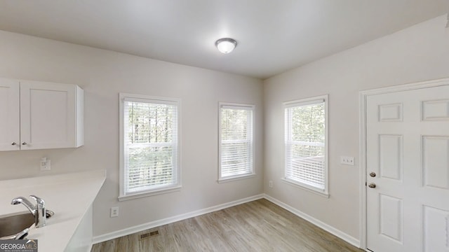 4912 Lightwood Ct NW, Acworth, GA 30102 - unfurnished dining area with light wood-style floors and baseboards