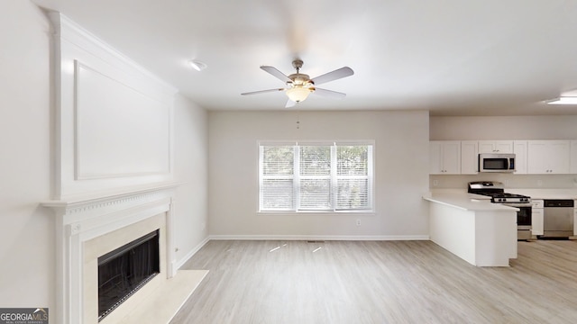 4912 Lightwood Ct NW, Acworth, GA 30102 - kitchen with appliances with stainless steel finishes, light wood-style floors, white cabinets, and ceiling fan