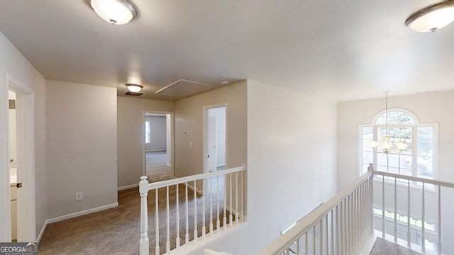 4912 Lightwood Ct NW, Acworth, GA 30102 - hall with attic access, healthy amount of natural light, carpet flooring, and baseboards