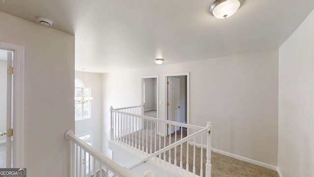 4912 Lightwood Ct NW, Acworth, GA 30102 - corridor featuring an upstairs landing, carpet floors, a chandelier, and baseboards