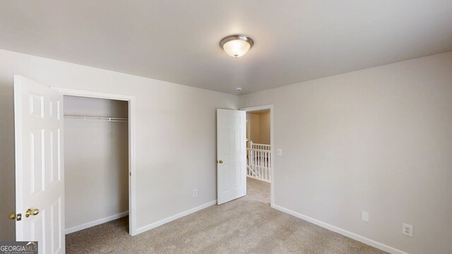 4912 Lightwood Ct NW, Acworth, GA 30102 - unfurnished bedroom featuring carpet, baseboards, and a closet