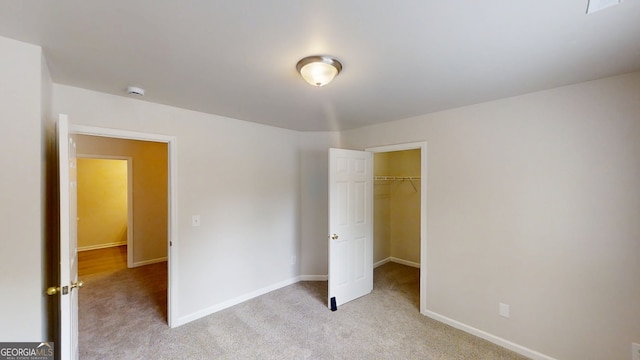 4912 Lightwood Ct NW, Acworth, GA 30102 - unfurnished bedroom featuring light carpet, baseboards, a spacious closet, and a closet
