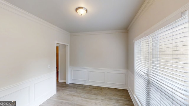 4912 Lightwood Ct NW, Acworth, GA 30102 - unfurnished room with healthy amount of natural light, wainscoting, ornamental molding, light wood-style flooring, and a decorative wall