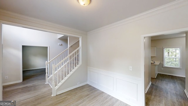 4912 Lightwood Ct NW, Acworth, GA 30102 - stairs with wood finished floors, crown molding, and a wainscoted wall