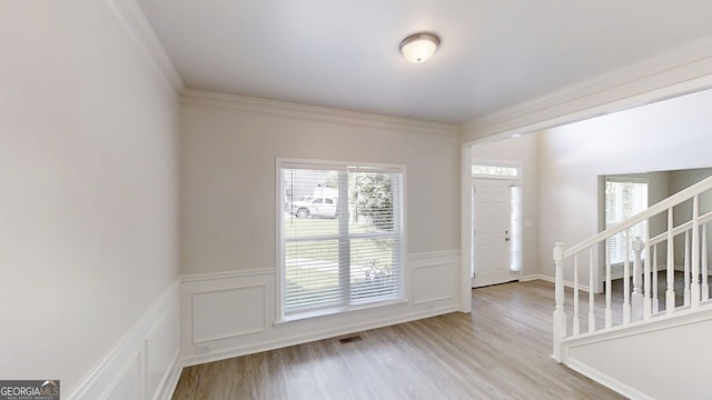 4912 Lightwood Ct NW, Acworth, GA 30102 - entrance foyer featuring stairway, plenty of natural light, wood finished floors, wainscoting, and a decorative wall