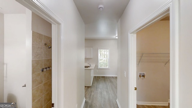 4912 Lightwood Ct NW, Acworth, GA 30102 - corridor featuring wood finished floors, a sink, and baseboards