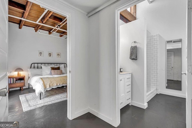 bedroom featuring concrete floors and baseboards
