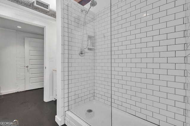 bathroom with a stall shower and baseboards