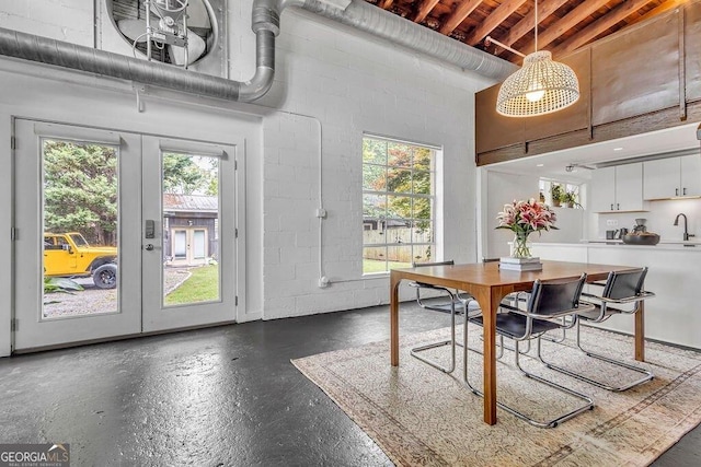 dining room featuring french doors and concrete block wall