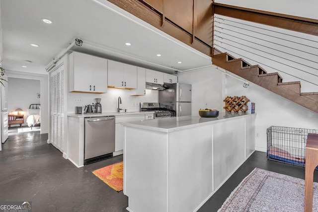 kitchen featuring stainless steel appliances, under cabinet range hood, light countertops, white cabinets, and recessed lighting
