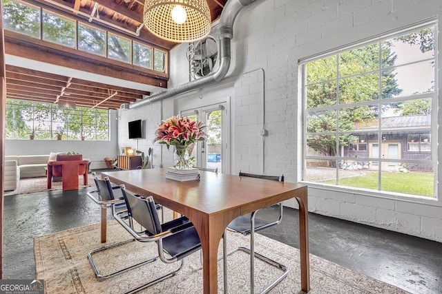 dining space featuring concrete block wall