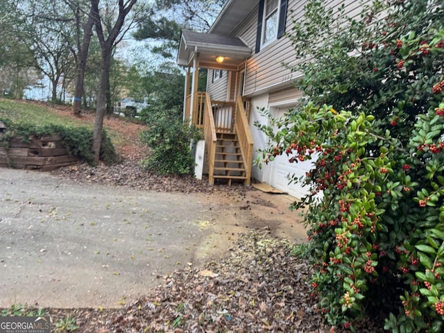 view of yard with stairway and an attached garage