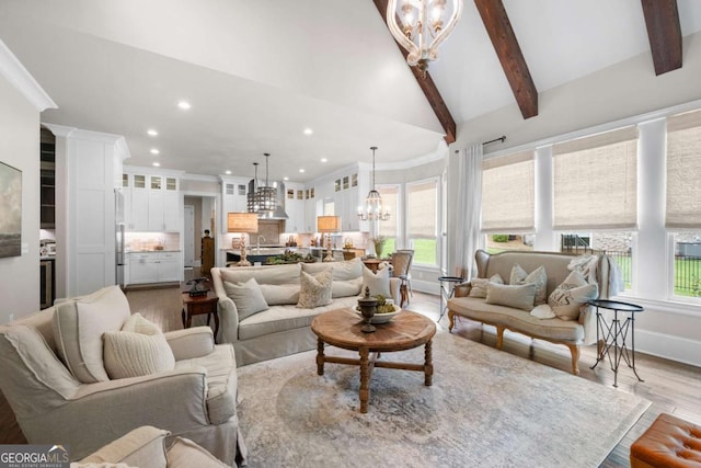 living area with a chandelier, light wood-style floors, recessed lighting, healthy amount of natural light, and ornamental molding