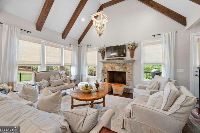living area featuring beam ceiling, wood finished floors, high vaulted ceiling, a chandelier, and a fireplace