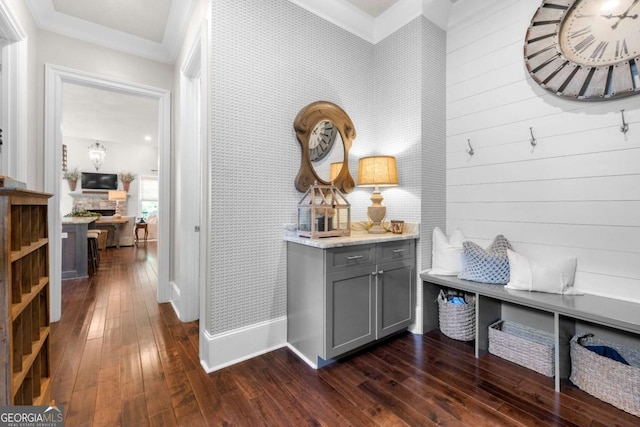 mudroom featuring dark wood-style floors, crown molding, and baseboards