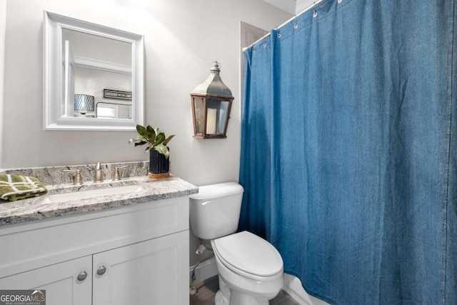 full bathroom featuring toilet, vanity, and a shower with curtain