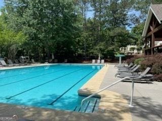 community pool featuring view of scattered trees