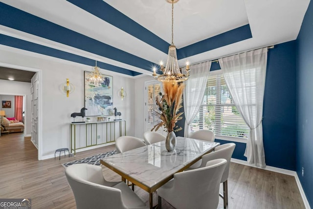 438 Southland Cir, Canton, GA 30115 - dining area with a chandelier, baseboards, wood finished floors, and a raised ceiling