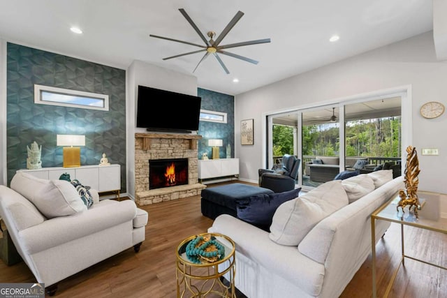 438 Southland Cir, Canton, GA 30115 - living area with an accent wall, ceiling fan, a stone fireplace, and recessed lighting