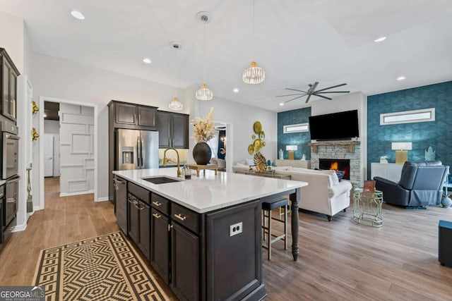438 Southland Cir, Canton, GA 30115 - kitchen with a sink, stainless steel appliances, ceiling fan, a breakfast bar area, and light countertops