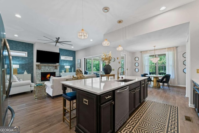 438 Southland Cir, Canton, GA 30115 - kitchen featuring a sink, appliances with stainless steel finishes, a ceiling fan, light countertops, and a fireplace