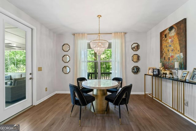 438 Southland Cir, Canton, GA 30115 - dining space featuring a chandelier, healthy amount of natural light, wood finished floors, and baseboards