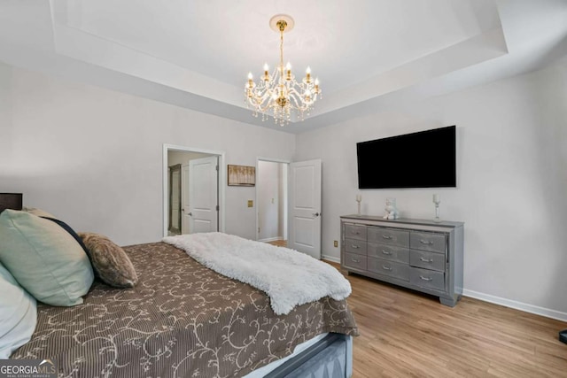 438 Southland Cir, Canton, GA 30115 - bedroom with baseboards, a chandelier, a raised ceiling, and wood finished floors