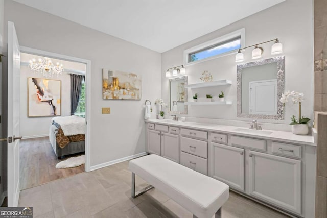 438 Southland Cir, Canton, GA 30115 - full bath with double vanity, a chandelier, ensuite bathroom, and baseboards