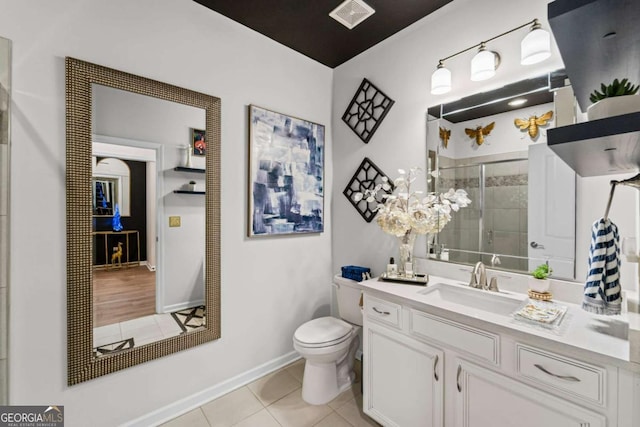 438 Southland Cir, Canton, GA 30115 - bathroom with tile patterned floors, toilet, vanity, a shower stall, and baseboards