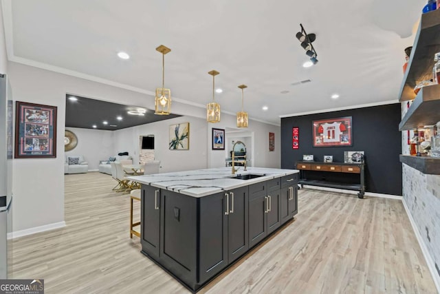 438 Southland Cir, Canton, GA 30115 - kitchen with a sink, light wood-style floors, a center island with sink, crown molding, and decorative light fixtures