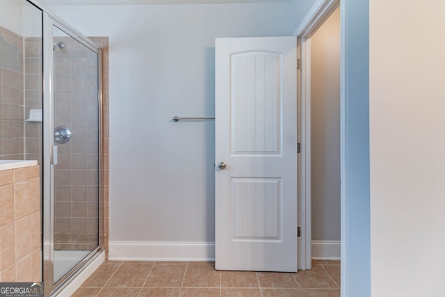 204 Saintvry Path, Atlanta, GA 30349 - bathroom with a shower stall, tile patterned floors, and baseboards