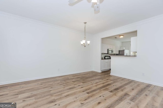 5138 Timber Hills Way, Oakwood, GA 30566 - unfurnished dining area with crown molding, a chandelier, ceiling fan, light wood finished floors, and baseboards