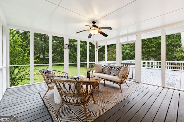 sunroom featuring ceiling fan and outdoor lounge area