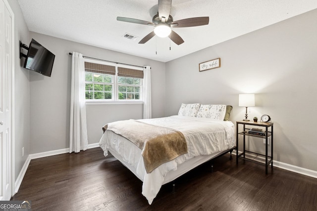 bedroom featuring wood finished floors, baseboards, and ceiling fan
