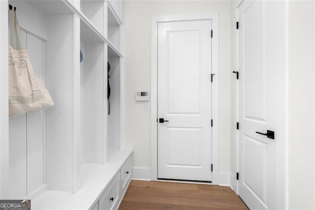mudroom featuring wood finished floors and baseboards