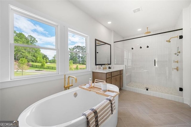 bathroom featuring a soaking tub, vanity, a stall shower, tile patterned flooring, and recessed lighting