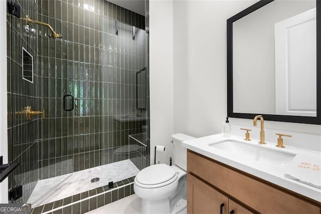 bathroom featuring a shower stall, toilet, and vanity