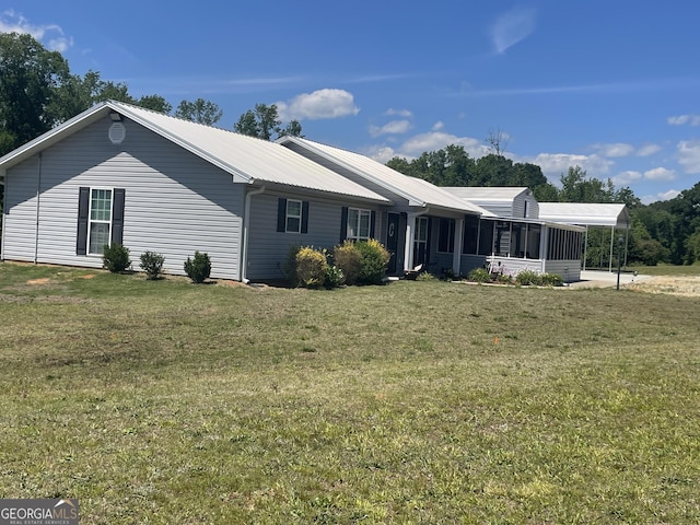 659 Voyles Rd, Carnesville, GA 30521 - view of side of home featuring a sunroom, a yard, a carport, and metal roof