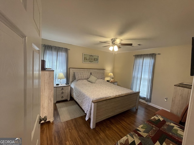 659 Voyles Rd, Carnesville, GA 30521 - bedroom featuring dark wood-style flooring, multiple windows, ceiling fan, and baseboards