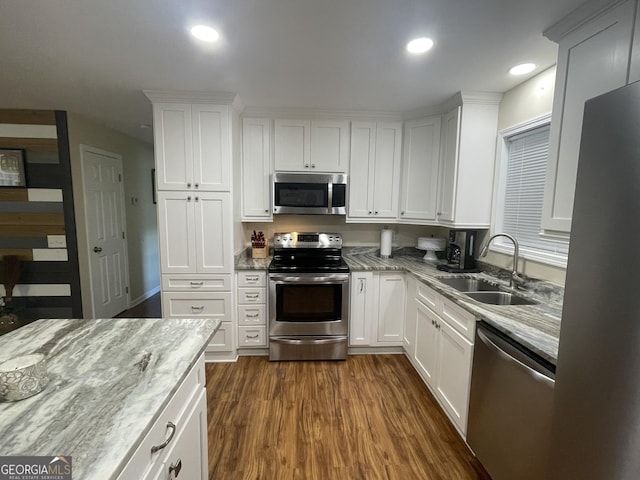 659 Voyles Rd, Carnesville, GA 30521 - kitchen with appliances with stainless steel finishes, a sink, white cabinets, dark wood finished floors, and light stone counters