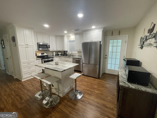 659 Voyles Rd, Carnesville, GA 30521 - kitchen featuring stainless steel appliances, a sink, white cabinetry, dark wood-style flooring, and light stone countertops