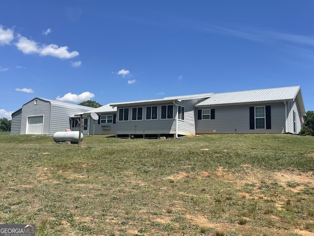659 Voyles Rd, Carnesville, GA 30521 - view of front facade with metal roof, a front yard, and a detached garage