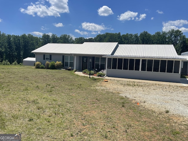 659 Voyles Rd, Carnesville, GA 30521 - view of front of property featuring a sunroom, metal roof, and a front lawn