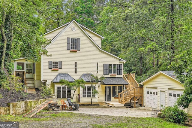 510 Aiken Dr, Dallas, GA 30157 - rear view of property featuring stairway, a detached garage, a wooden deck, and a patio area