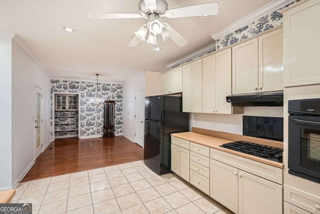 510 Aiken Dr, Dallas, GA 30157 - kitchen with wallpapered walls, black appliances, crown molding, under cabinet range hood, and cream cabinets