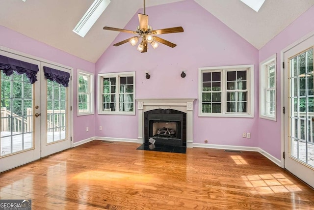 510 Aiken Dr, Dallas, GA 30157 - unfurnished living room featuring high vaulted ceiling, a skylight, a fireplace with flush hearth, wood finished floors, and ceiling fan