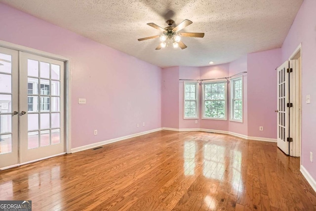 510 Aiken Dr, Dallas, GA 30157 - unfurnished room with french doors, hardwood / wood-style flooring, a textured ceiling, a ceiling fan, and baseboards