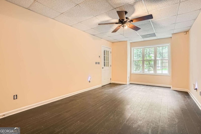 510 Aiken Dr, Dallas, GA 30157 - spare room featuring a paneled ceiling, ceiling fan, dark wood-style flooring, and baseboards