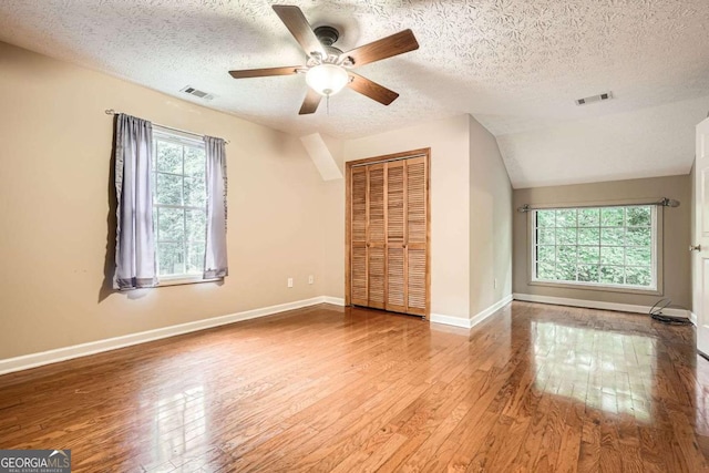 510 Aiken Dr, Dallas, GA 30157 - additional living space featuring hardwood / wood-style flooring, a textured ceiling, a ceiling fan, baseboards, and lofted ceiling
