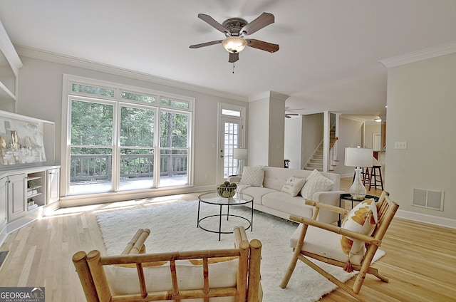 112 Windalier Rdg, Peachtree City, GA 30269 - living room featuring ceiling fan, ornamental molding, light wood finished floors, stairs, and baseboards